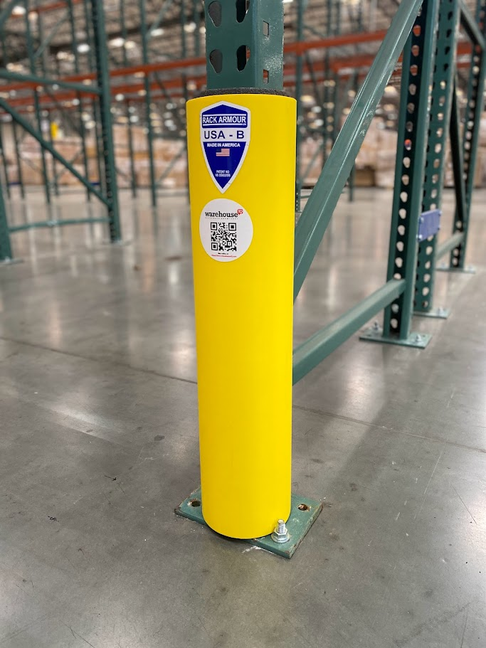 a yellow rack protector in the middle of a Bay Area warehouse protecting pallet racking
